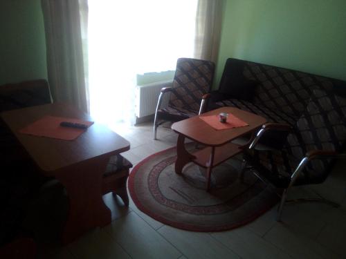 a living room with a couch and a table at Ośrodek Wczasowy "GRONOSTAJ" in Rajcza