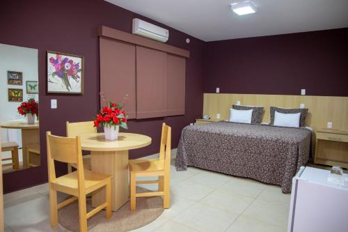 En eller flere senge i et værelse på Hotel Bem Estar