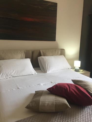 a bedroom with a bed with two pillows and a painting at A casa di Gio in Lecce