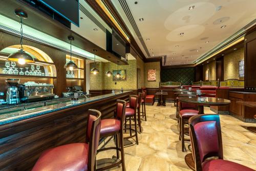 a bar with chairs and tables in a restaurant at Gulf Inn Hotel Al Nasr Formerly Roda Links Al Nasr in Dubai