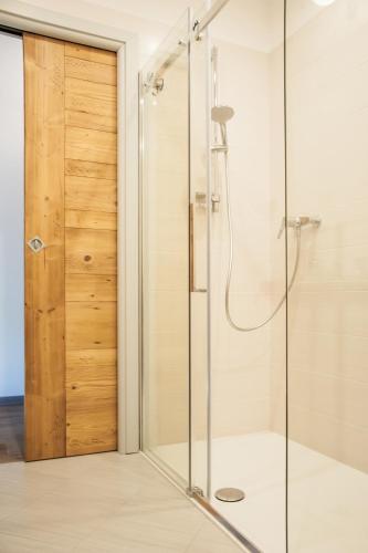 a shower with a glass door in a bathroom at b&b Casa Tavernaro in Fiera di Primiero