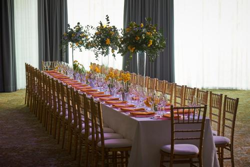 a long table with chairs and wine glasses on it at Kimpton Charlotte Square by IHG in Edinburgh