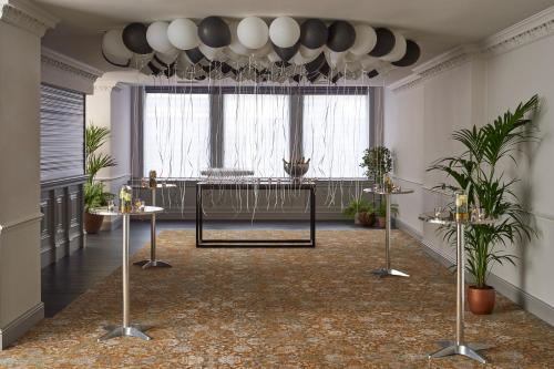 a room with plants and a large window at Kimpton Charlotte Square by IHG in Edinburgh