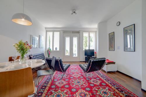 a living room with a table and chairs and a rug at Nosislav Apartments in Nosislav