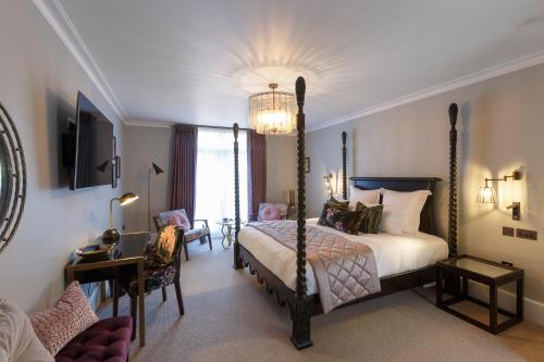 a bedroom with a bed and a chandelier at Gonville Hotel in Cambridge