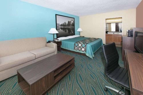 a hotel room with a couch and a bed at Super 8 by Wyndham Duncan in Duncan