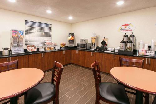 a restaurant with tables and chairs and a counter at Super 8 by Wyndham Duncan in Duncan