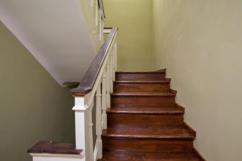 a staircase with wooden floors and white railings at Hostel Adriatic Piran in Piran
