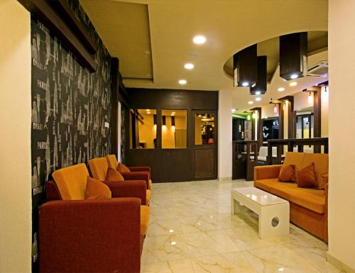 a lobby with couches and a table in a building at Star Emirates Inn Hotel Salalah in Salalah