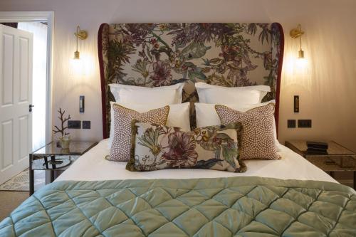 a bedroom with a large bed with pillows at Gonville Hotel in Cambridge