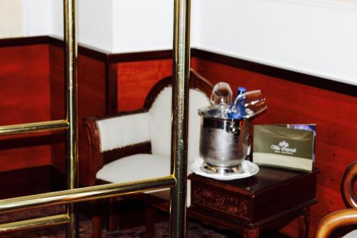 a chair with a bucket of tooth brushes on a table at Balconata 2.0 Banqueting & Accommodations in Lucera