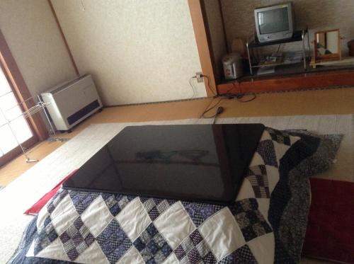 a glass box sitting on the floor in a room at Miyasakaya in Nozawa Onsen