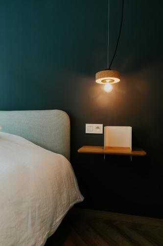 a bedroom with a bed and a table with a laptop at Hotel Jerom in Kalmthout