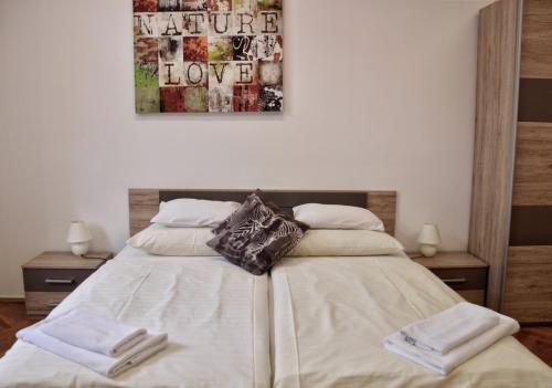 a bedroom with a bed with two towels on it at Apartment Trdinova in Ljubljana