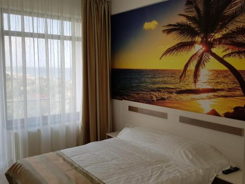 a bedroom with a palm tree painting on the wall at Lotus 7 Silver in Mamaia