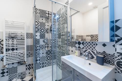 ローマにあるVatican Stemar Apartmentのバスルーム(洗面台、ガラス張りのシャワー付)
