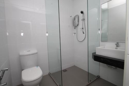 a bathroom with a toilet and a sink and a shower at Alor Boutique Hotel Sdn Bhd in Kuala Lumpur