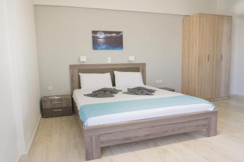 a bedroom with a large bed with two towels on it at Thegaia Studios in Rethymno Town