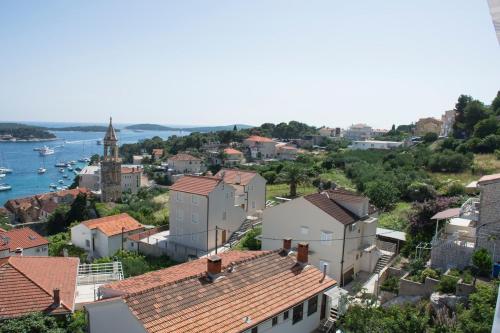 a view of a town with buildings and the water at Apartments Boćin Rosso in Hvar