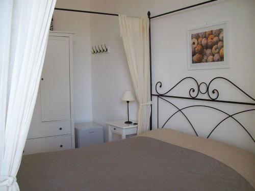 a bedroom with a bed and a picture of fruit at Porta del Mare in Portoferraio