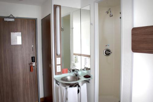 La salle de bains est pourvue d'un lavabo et d'un miroir. dans l'établissement Hotel Hi! Santa Catarina, à Monterrey