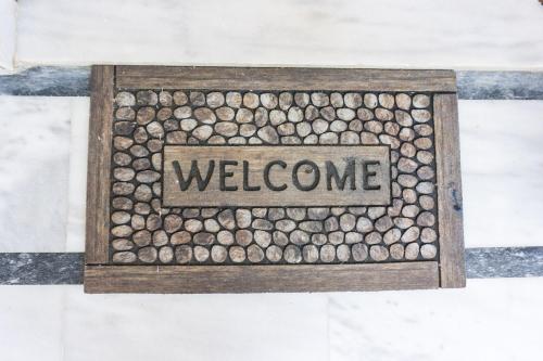 a drawing of a welcome sign in a wooden box at Thegaia Studios in Rethymno