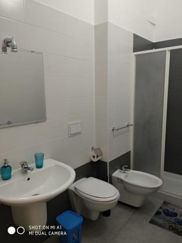 a bathroom with a sink and a toilet and a mirror at B&B Il mandorlo in Polignano a Mare