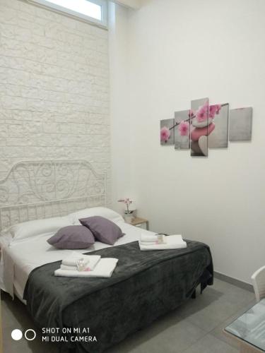 a bedroom with a bed with two towels on it at B&B Il mandorlo in Polignano a Mare