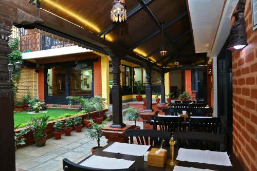 a patio with tables and chairs in a restaurant at Taleju Boutique Hotel in Kathmandu