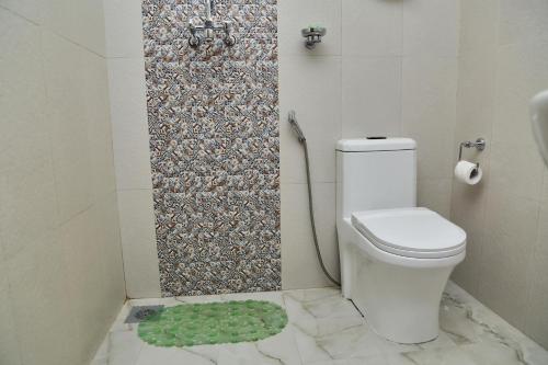 a bathroom with a toilet, sink, and shower stall at Taleju Boutique Hotel in Kathmandu