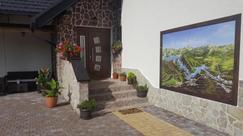 a painting on the side of a house with plants at Villa Stone in Rakovica