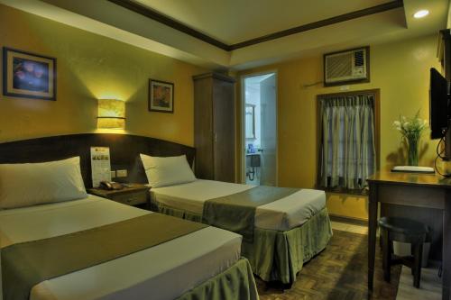 A bed or beds in a room at Fersal Hotel - Manila