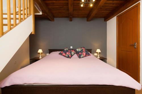 a bedroom with a large white bed with two pillows at Apartment Atlantis in Pula