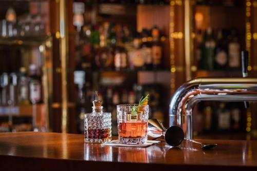 a drink sitting on a table in a bar at Best Western Plus Delta Park Hotel in Mannheim