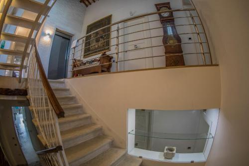 a staircase with a glass shelf with a clock on it at A casa di V-Ale in Treviso