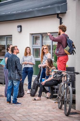 a group of people standing outside of a building at Wild Atlantic Hostel in Leenaun