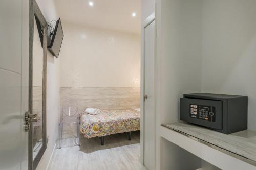 Letto o letti in una camera di Hostal Met Madrid
