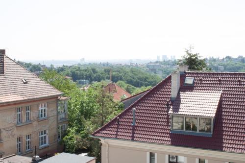 a view of roofs of buildings in a city at Flamingo Apartments in Prague