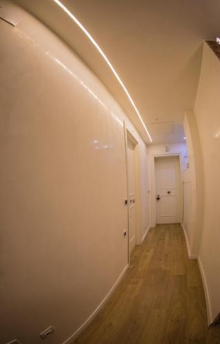an empty hallway with a white door and a stairway at A casa di V-Ale in Treviso