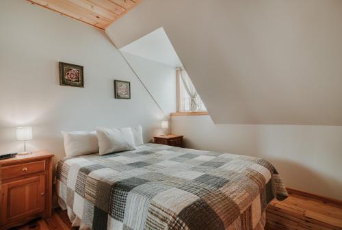 a bedroom with a bed with a checkered blanket at Royal Laurentien in Mont-Blanc