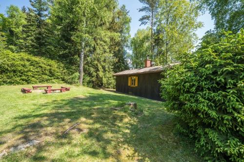 a cabin in the woods with a picnic table at Chata Kytlice in Kytlice