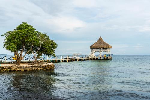 a pier with a gazebo in the middle of the water at Quinta del Mar Tintipán in Isla Mucura