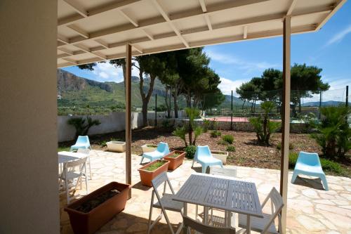 a patio with a table and chairs and a view at Boa Vista San Vito - Area Fitness, Barbecue Area, Tennis Court in San Vito lo Capo