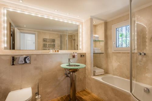 a bathroom with a sink and a shower and a tub at The Residence by the Beach House Marbella in Marbella