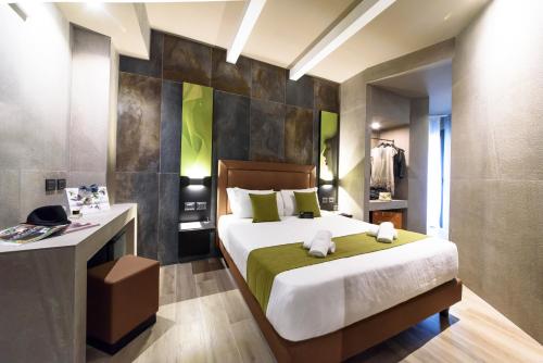 a bedroom with a bed and a dresser in a room at Just Hotel Milano in Milan