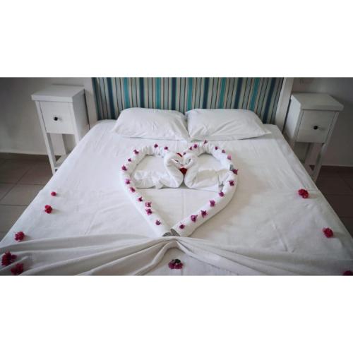 a bed with two hearts painted on it at Gumbet Cove Hotel in Gümbet
