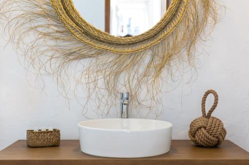 a bathroom with a sink and a mirror at Hostal La Torre Ibiza Cap Negret in San Antonio