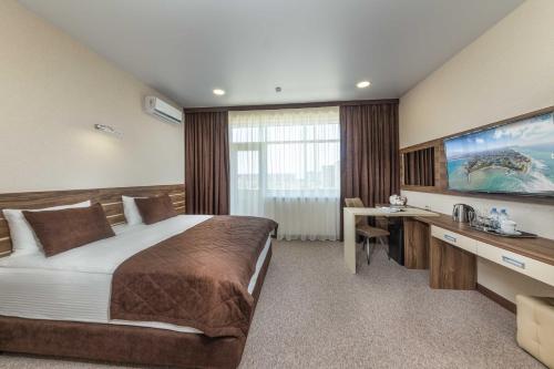 a hotel room with a bed and a desk at Imperial Sun in Anapa