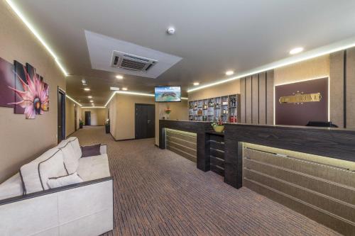 a lobby of a hotel with a bar and a couch at Imperial Sun in Anapa