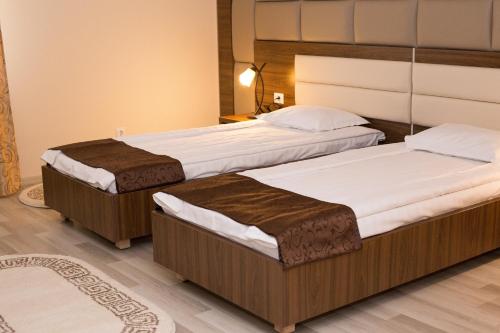 two twin beds in a hotel room with at Complex Azar in Galaţi